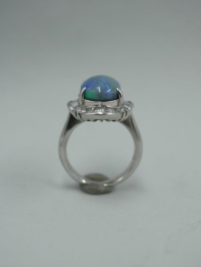 null 
18K white gold skirt ring set with a cabochon opal of 5cts in a setting of...