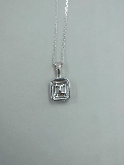null Pendant in 18K white gold set with baguette and brilliant diamonds. Accompanied...