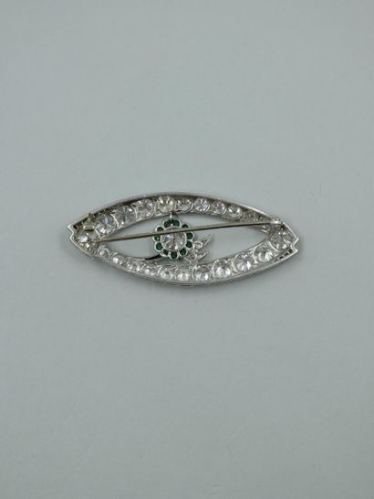 null A platinum brooch with an openwork design paved with brilliant-cut and old-cut...