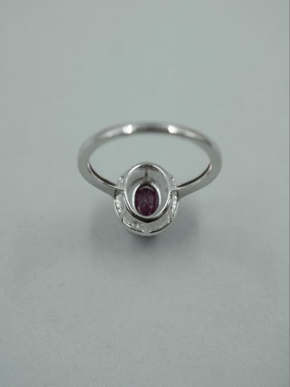 null Art Deco style ring in 18k white gold set with an oval ruby surrounded by black...