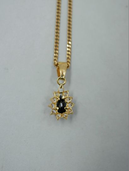 null An 18K yellow gold flower pendant with a pear-shaped spinel in a diamond setting....