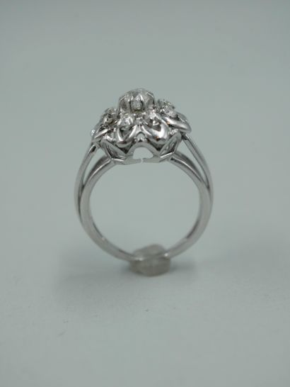null 
18K white gold flower ring set with a central brilliant-cut diamond in a setting...