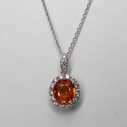 null Pendant in 18K white gold set in its center with an oval orange sapphire of...