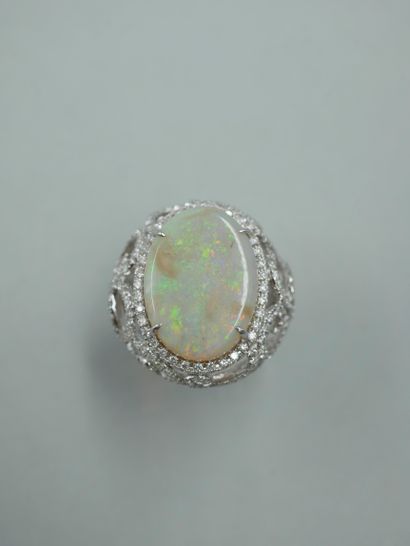 null 18k white gold ring set with a 10ct opal in an openwork design with arabesques...