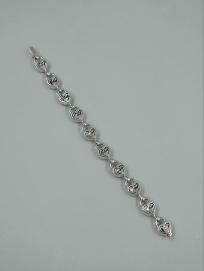 null Bracelet in 18k white gold with heart-shaped links, three of which are paved...