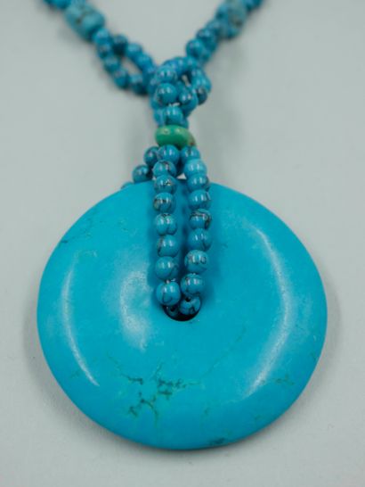 null Turquoise disc Bi pendant held by a chain of turquoise beads alternated with...