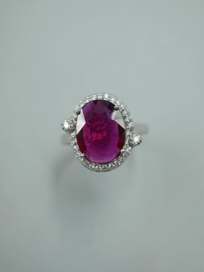 null 18K white gold ring set with a 3.02ct natural oval ruby in a diamond setting...