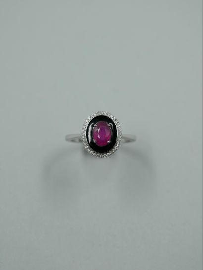 null Art Deco style ring in 18k white gold set with an oval ruby surrounded by black...