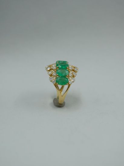 null 18k yellow gold openwork band ring set with seven oval emeralds surrounded by...
