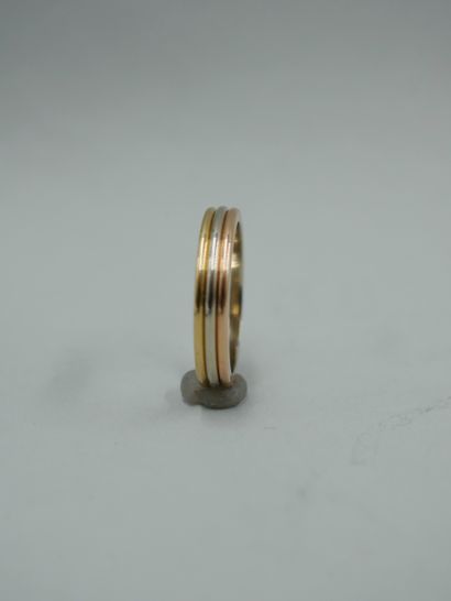 null CARTIER. Trinity wedding band in three 18K gold, signed and numbered 980914....