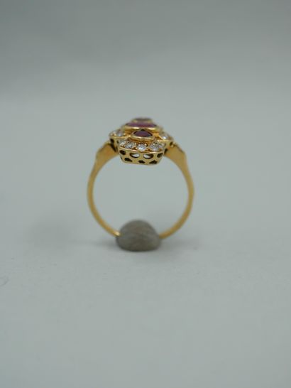 null An 18K yellow gold ring set with three oval and pear-shaped rubies in a setting...