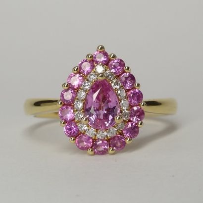 null 18K yellow gold drop ring set in its center with a pear cut pink sapphire in...