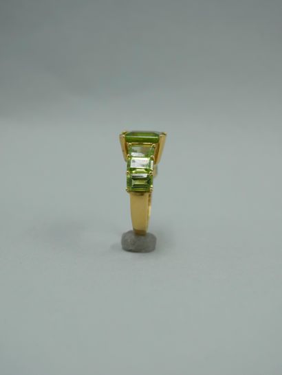 null 18K yellow gold ring set with seven degree-cut peridots, the largest in the...