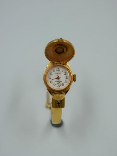 null DAMY. Lady's wristwatch in gilt metal, the dial with a window hidden by a faceted...