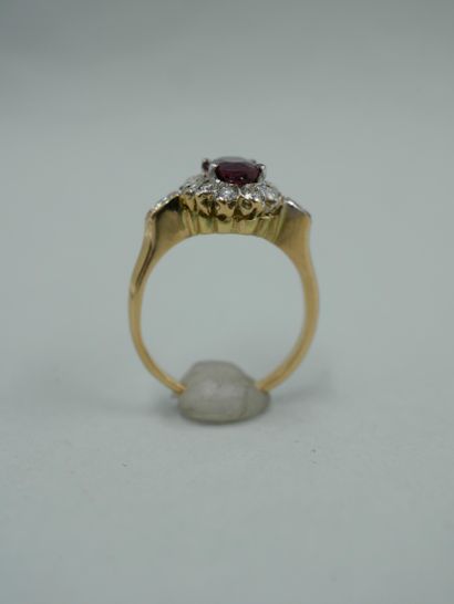 null An 18K yellow gold flower ring set with an oval ruby weighing approximately...