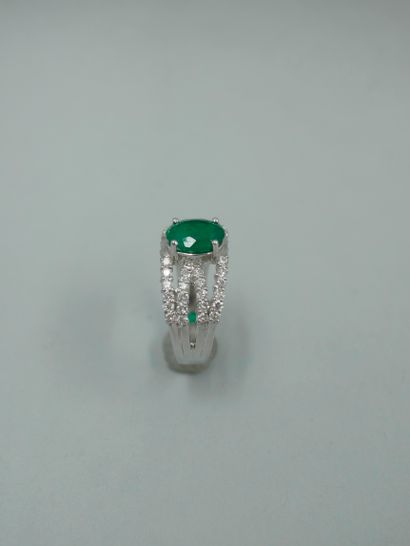 null 18K white gold openwork ring set with an oval emerald probably from Colombia...