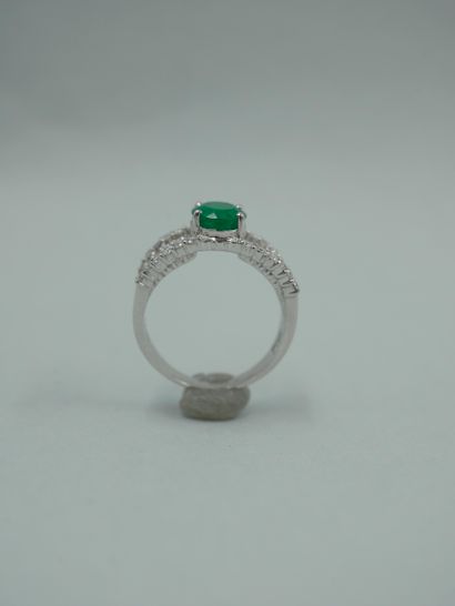 null 18K white gold openwork ring set with an oval emerald probably from Colombia...
