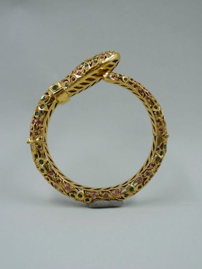 null Gold-plated openwork metal bracelet featuring a snake, set with emeralds and...