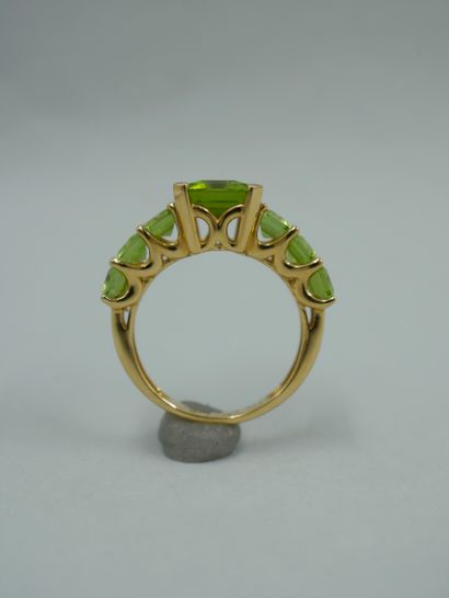 null 18K yellow gold ring set with seven degree-cut peridots, the largest in the...