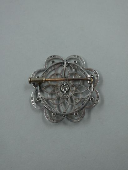 null A 14k white gold openwork rosette brooch with a central brilliant-cut diamond...
