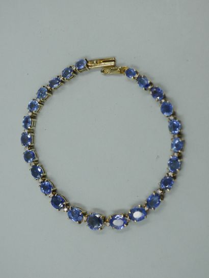 null Line bracelet in 14k yellow gold set with 24 oval and round sapphires interspersed...