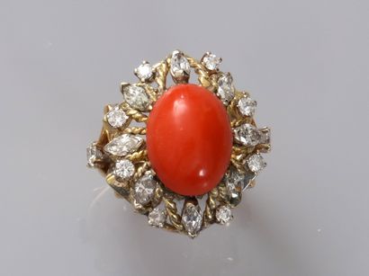 null 18k yellow gold ring centered on an oval coral cabochon in a setting of brilliant-cut...