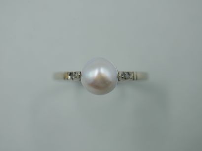null 18k white gold ring with a half cultured pearl in the center and small rose-cut...