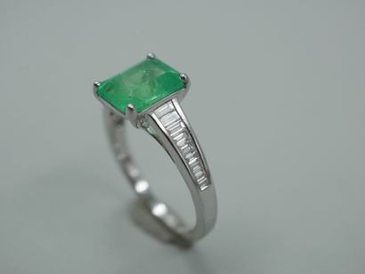null An 18k white gold ring set with a 2.40cts emerald cut emerald and baguette cut...