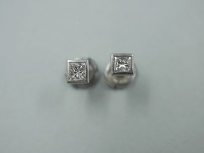 null Pair of 18k white gold studs set with princess cut diamonds of 0.15cts each....