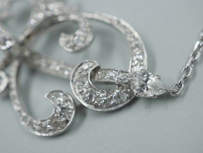 null A platinum openwork scroll necklace, paved with diamonds and accented on either...