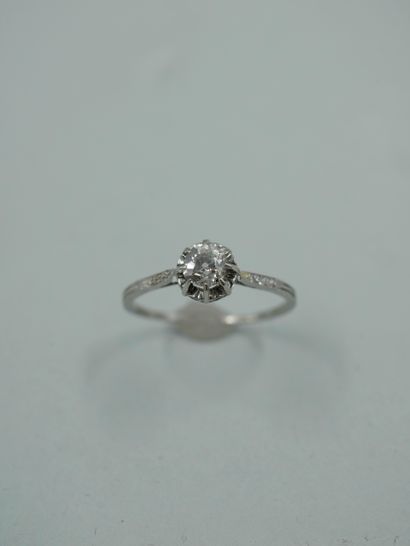 null A platinum solitaire ring set with a claw-set old-cut diamond in an openwork...