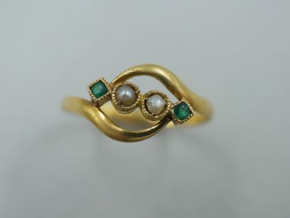 null An 18k yellow gold openwork ring set with pearls and two emeralds. Work of the...