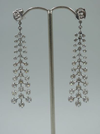 null Pair of 18k white gold "atom" earrings set with 4ct brilliant cut diamonds....