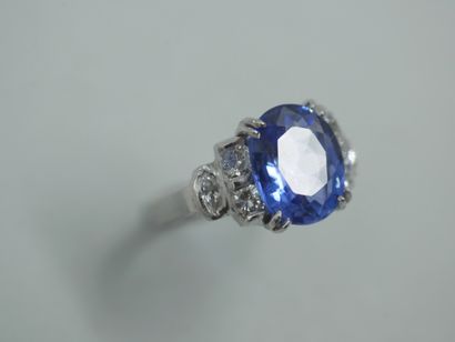 null An Art Deco style ring in 18k white gold centered on a sapphire weighing approximately...