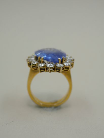 null An 18k white and yellow gold pompadour ring set with a large clear sapphire...