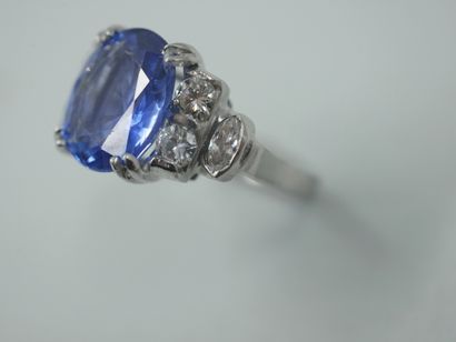 null An Art Deco style ring in 18k white gold centered on a sapphire weighing approximately...