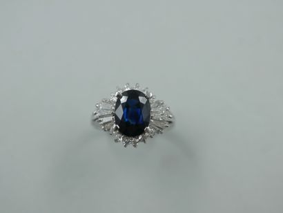 A platinum skirt ring set with a 2ct oval...