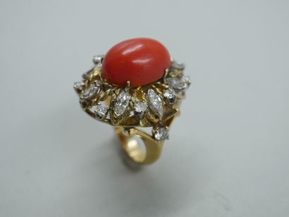 null 18k yellow gold ring centered on an oval coral cabochon in a setting of brilliant-cut...