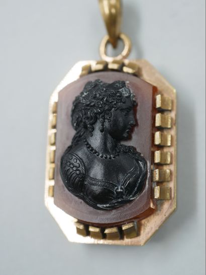 null A copper pendant with a carnelian cameo representing a woman in profile. Period...