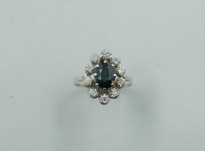 null 
Marquise ring in 18k white gold, centered on a doublet sapphire surrounded...