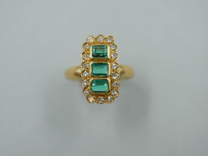 null An 18k yellow gold marquise ring with a rectangular bezel set with three emerald-cut...