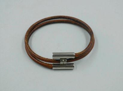 null HERMES Paris. Brown leather and silver plated metal "Tournis" bracelet. Signed....