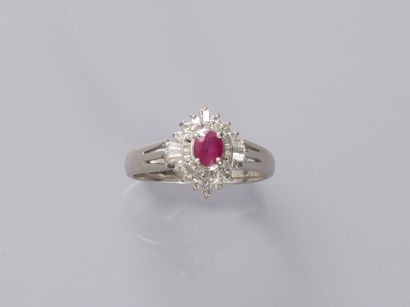 null 
An 18k white gold flower ring set with a 0.30ct natural oval ruby in a setting...