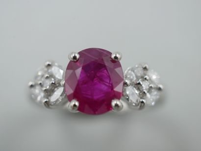 null Platinum ring centered on a ruby of 1.70 cts approximately accosted by motifs...