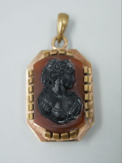 null A copper pendant with a carnelian cameo representing a woman in profile. Period...