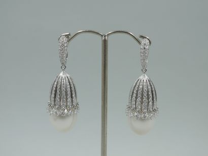 null A pair of 18k white gold earrings each composed of a large cultured pearl set...