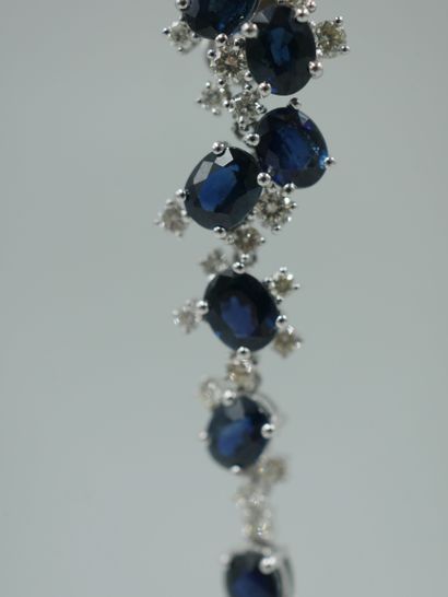 null Pair of 18k white gold earrings each set with eight oval sapphires for 7cts...