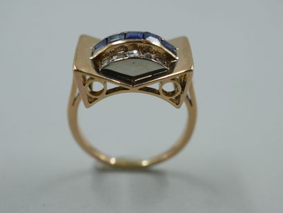 null 
18k yellow gold bridge ring set with a line of calibrated sapphires between...