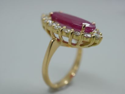 null A yellow gold marquise ring centered on a 5.05 ct ruby in a surround of diamonds...