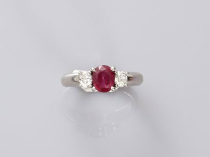 null 
Platinum trilogy ring set with a round ruby of about 1ct and two oval diamonds...